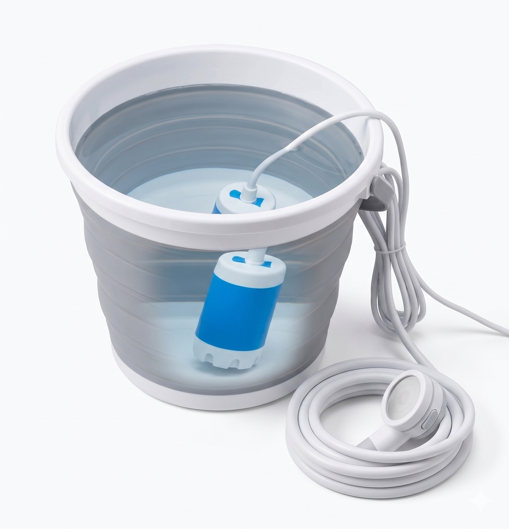 The blue and white submersible pump sitting in a collapsible bucket of water with the coiled hose and shower head beside it on a white background